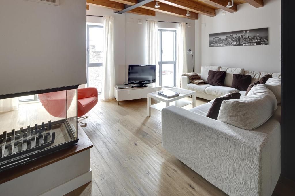 a living room with a couch and a tv at Val Arties 3 by FeelFree Rentals in Arties