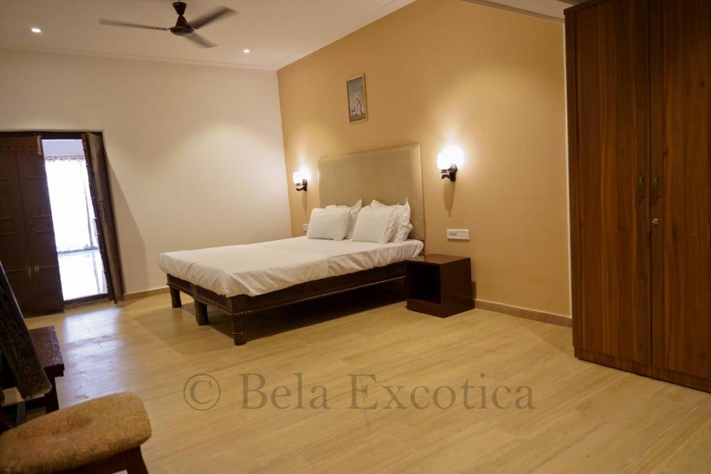 a bedroom with a bed in a room at Bela exotica in Mahabaleshwar