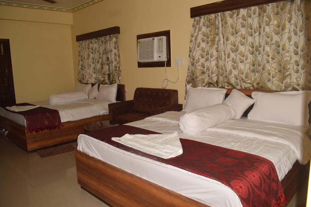 En eller flere senge i et værelse på Hotel Darpana