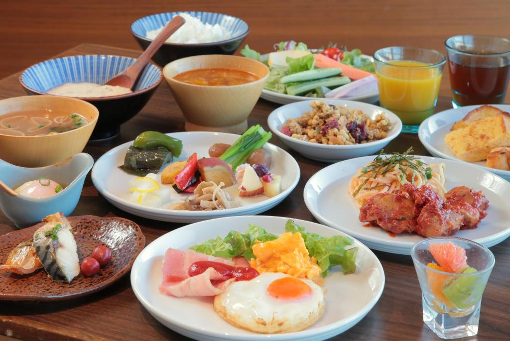 a wooden table with plates of food on it at Odakyu Hotel Century Sagami Ono in Sagamihara