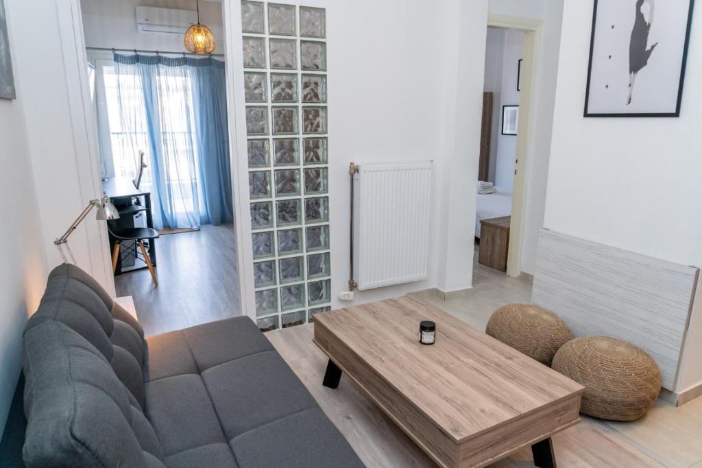 a living room with a couch and a coffee table at Kosmos Service Apartment Near Saint Dimitrious Church in Thessaloniki