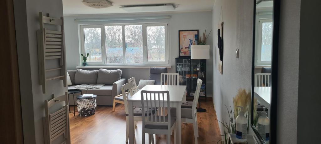 a living room with a table and a couch at Viscosa Holiday Apartment in Kõrgessaare