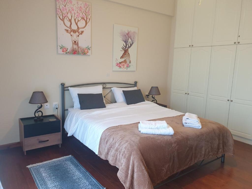 a bedroom with a bed with two towels on it at Great View City Appartment in Agios Rokkos