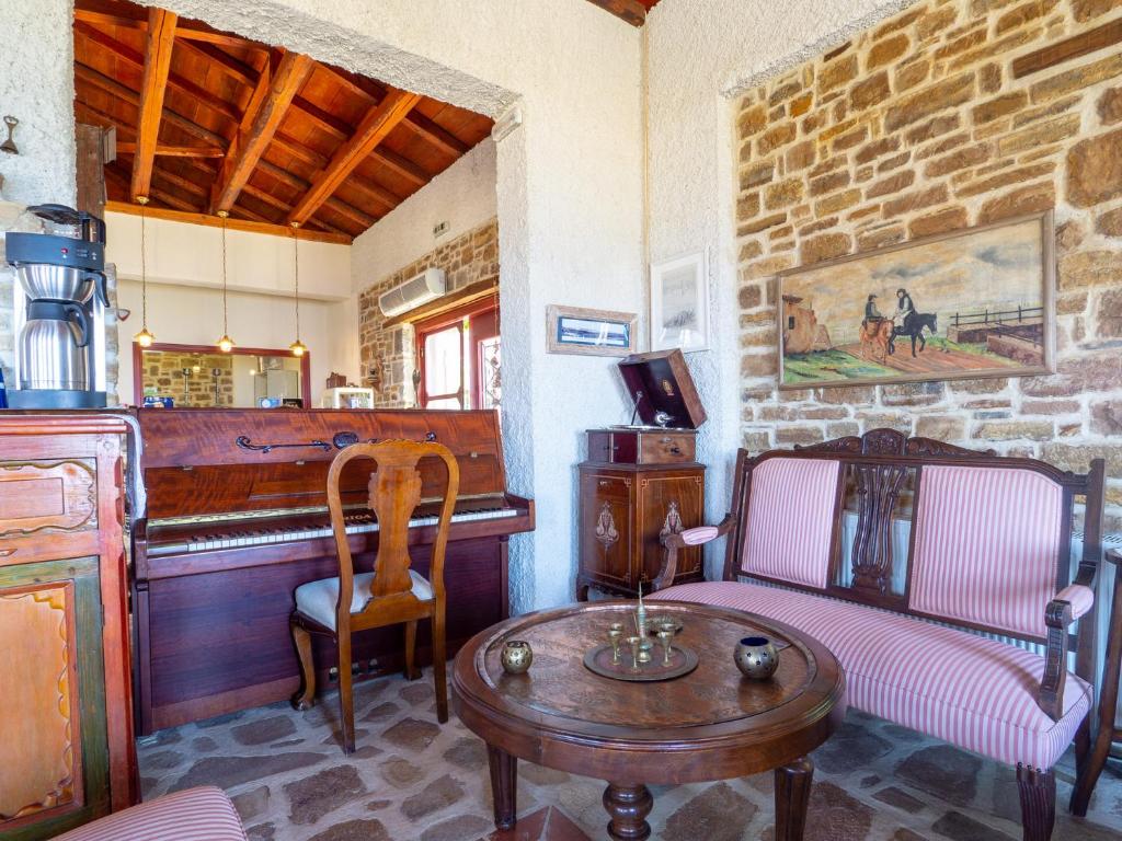 a living room with a table and chairs and a counter at Ethaleia Hotel in Moúdhros