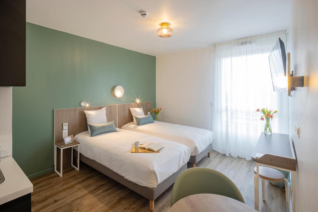 Кровать или кровати в номере All Suites Appart Hotel Le Havre