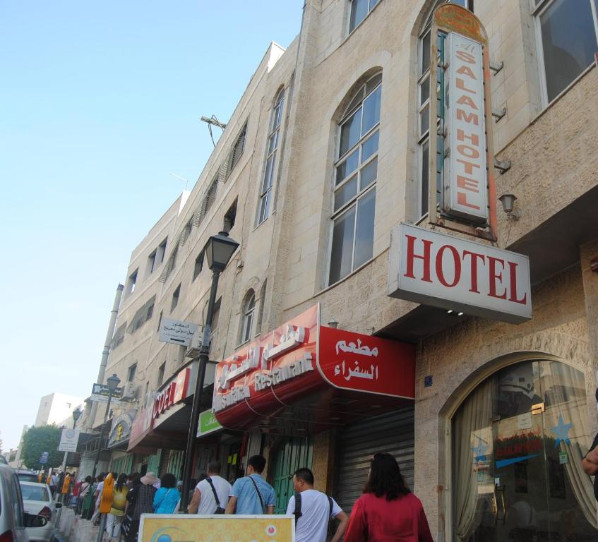 people walking on a street in front of a hotel at Al Salam Hotel in Bethlehem