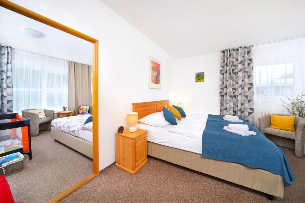 Postel nebo postele na pokoji v ubytování Hotel Lenka