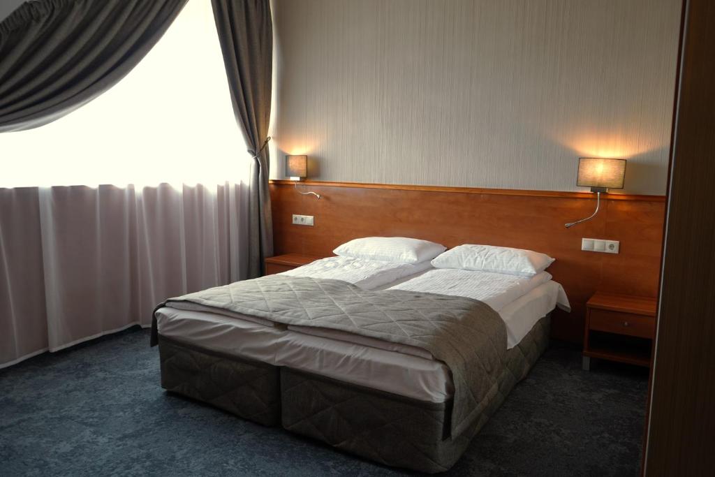 Postel nebo postele na pokoji v ubytování Hotel Porto