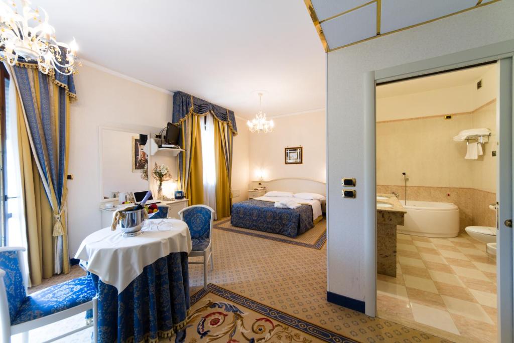 a hotel room with two beds and a bathroom at Vald Hotel in Val Della Torre