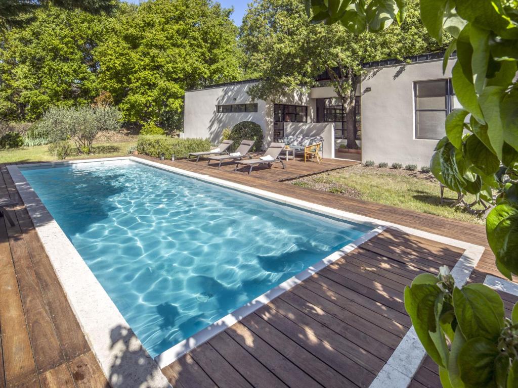 a swimming pool in the backyard of a house at Holiday Home Villa Isabelle by Interhome in Gondonnets