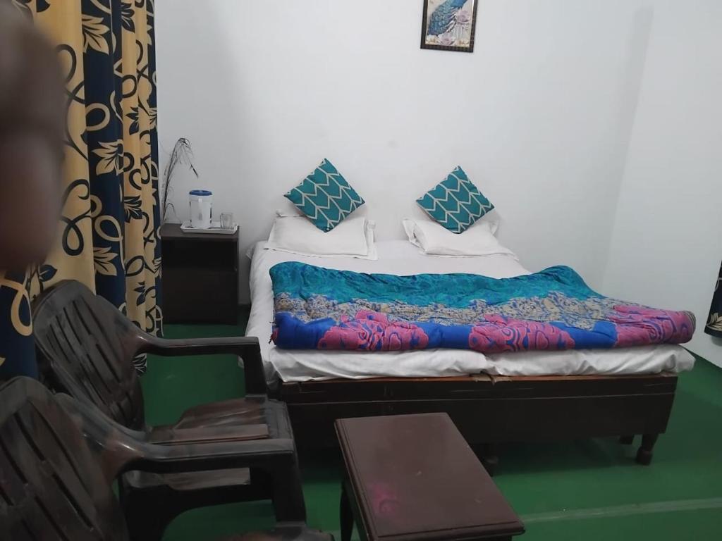 A bed or beds in a room at Shivam Hotel & Restaurant