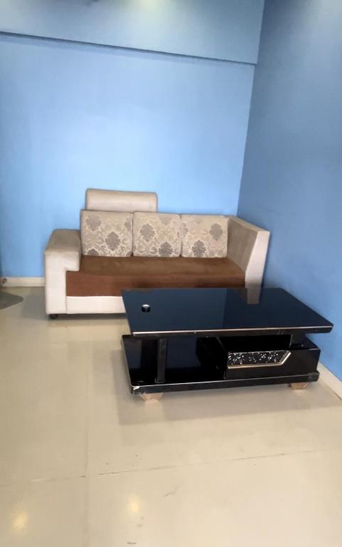 a living room with a couch and a table at 30th floor 2BHK near Viviana Mall with Balcony & Car Parking in Thane