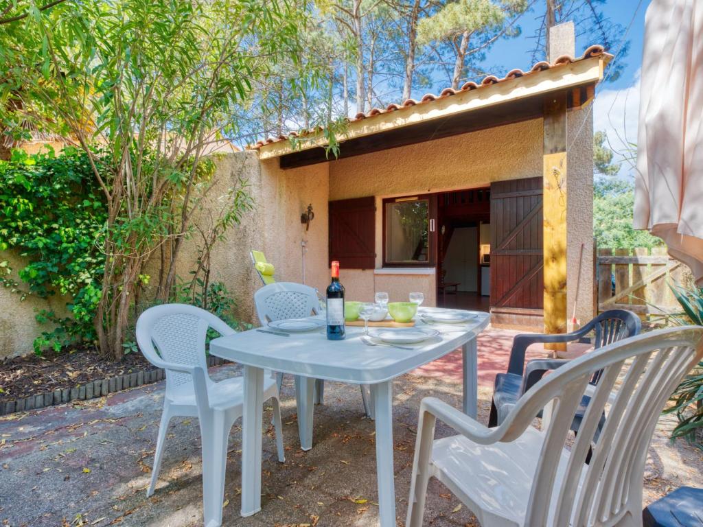 a table and chairs on the patio of a house at Holiday Home Les As-2 by Interhome in Lacanau-Océan