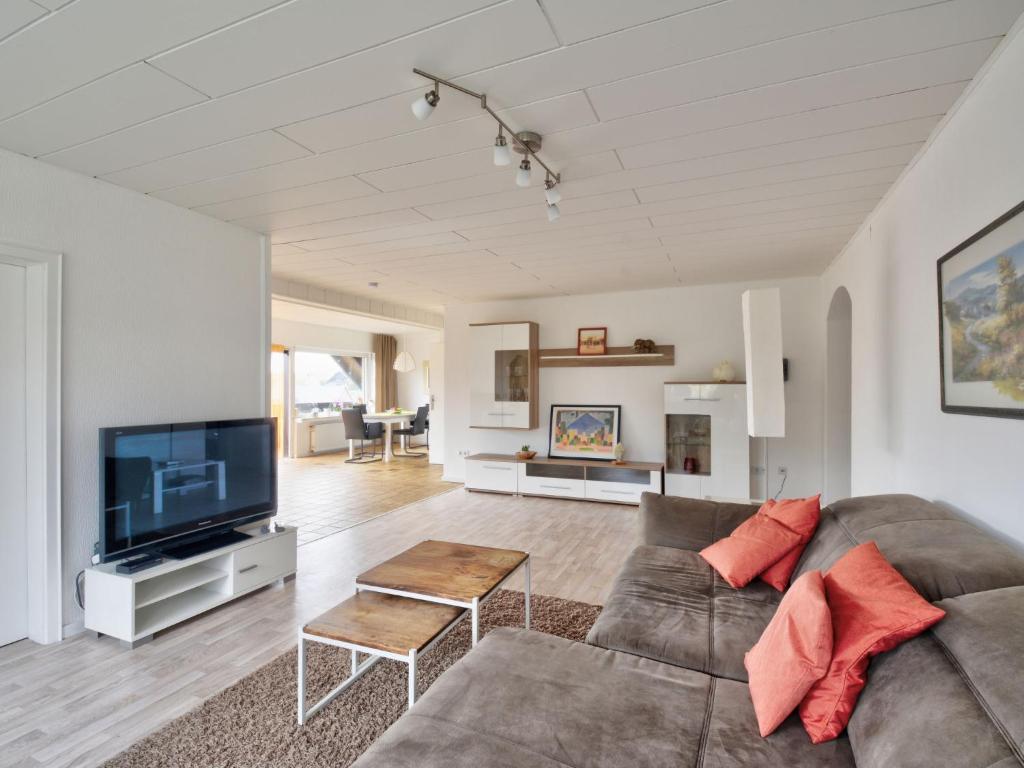 a living room with a couch and a tv at Apartment Waldvogt by Interhome in Lothe