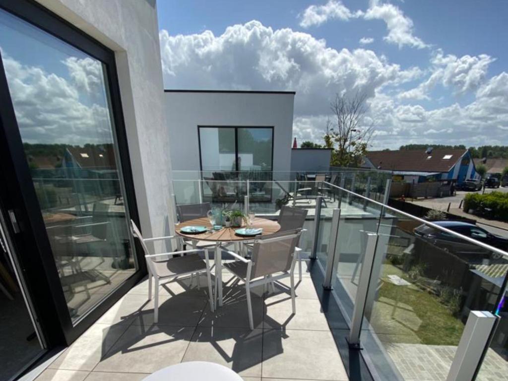 a balcony with a table and chairs on it at Holiday Home Bredunepark-2 by Interhome in Bredene