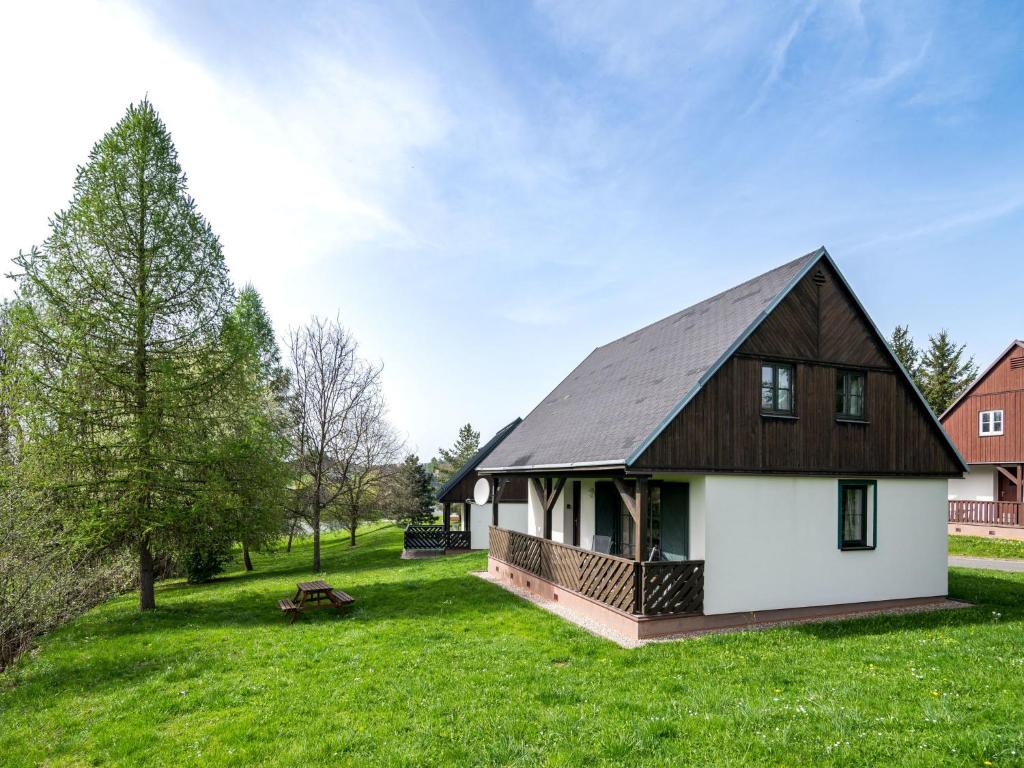 a house with a gambrel roof on a green field at Holiday Home Holiday Hill 40 by Interhome in Černý Dŭl