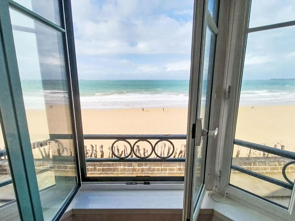 a view of the beach from the balcony of a condo at Apartment Les Armateurs by Interhome in Saint Malo