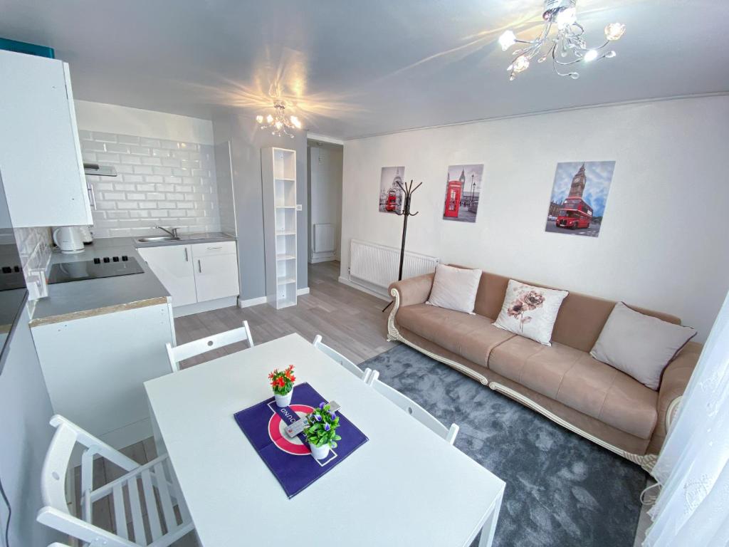 a living room with a white table and a couch at 2 Bed Flat, Dalston Junction, London in London
