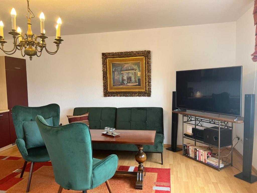 a living room with a couch and a table and a tv at Apartment Neuensien 11a in Seedorf