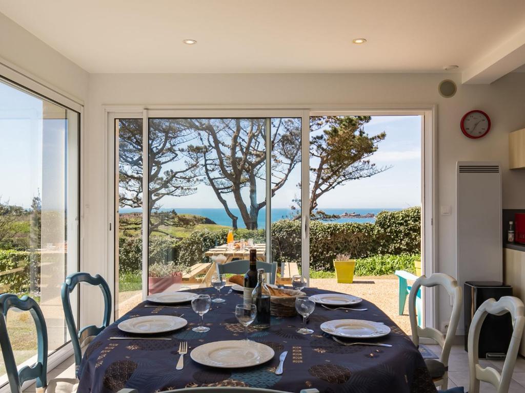 a dining room with a table and a view of the ocean at Holiday Home La maison de Toul an Dour by Interhome in Plouarzel