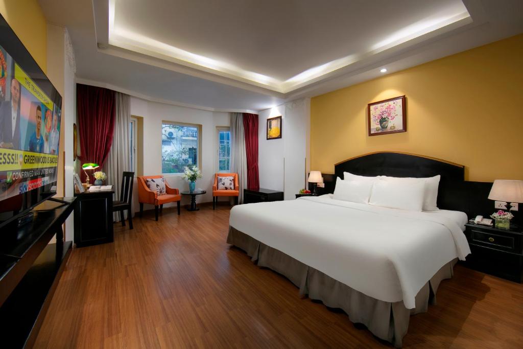 Postel nebo postele na pokoji v ubytování Hanoi Harmonia Hotel & Spa
