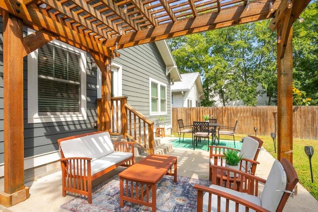 a patio with chairs and a wooden pergola at Location Walk to Coffee Shops mins to Downtown in Nashville