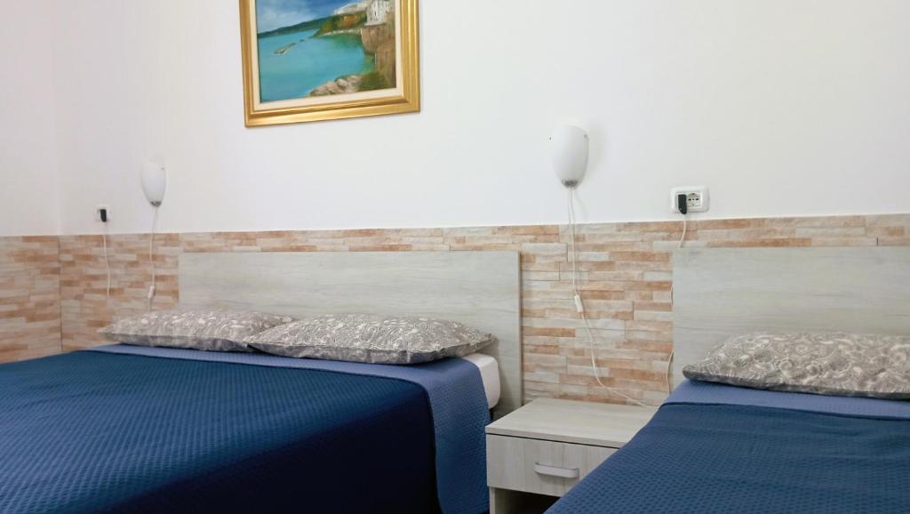 En eller flere senger på et rom på Hotel Residence Villa Ascoli
