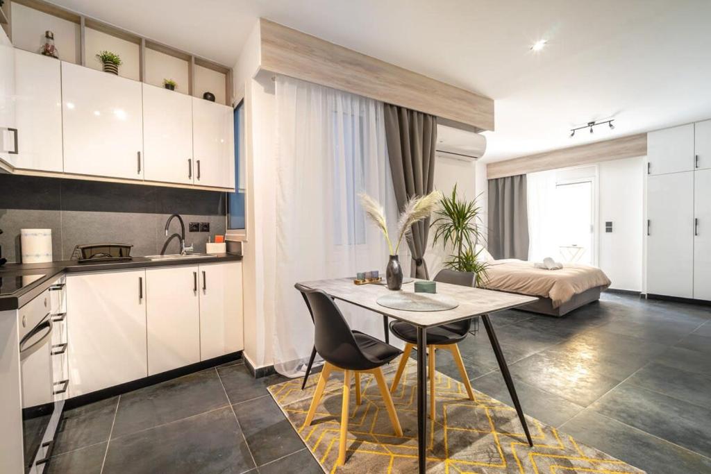 a kitchen with a table and chairs in a room at Apartment anghome A3 in Metaksourgio in Athens