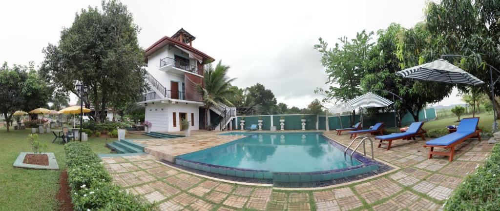 uma casa com piscina num quintal em The Nilambara Lake View em Dambulla