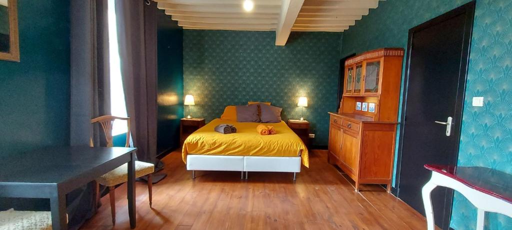 a bedroom with a bed and a wooden floor at B&amp;B Bon Vivant in Brinay