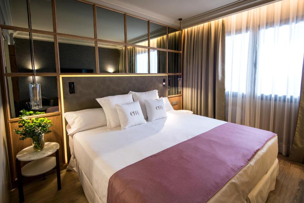 a hotel room with a large bed and a window at Barceló Emperatriz in Madrid