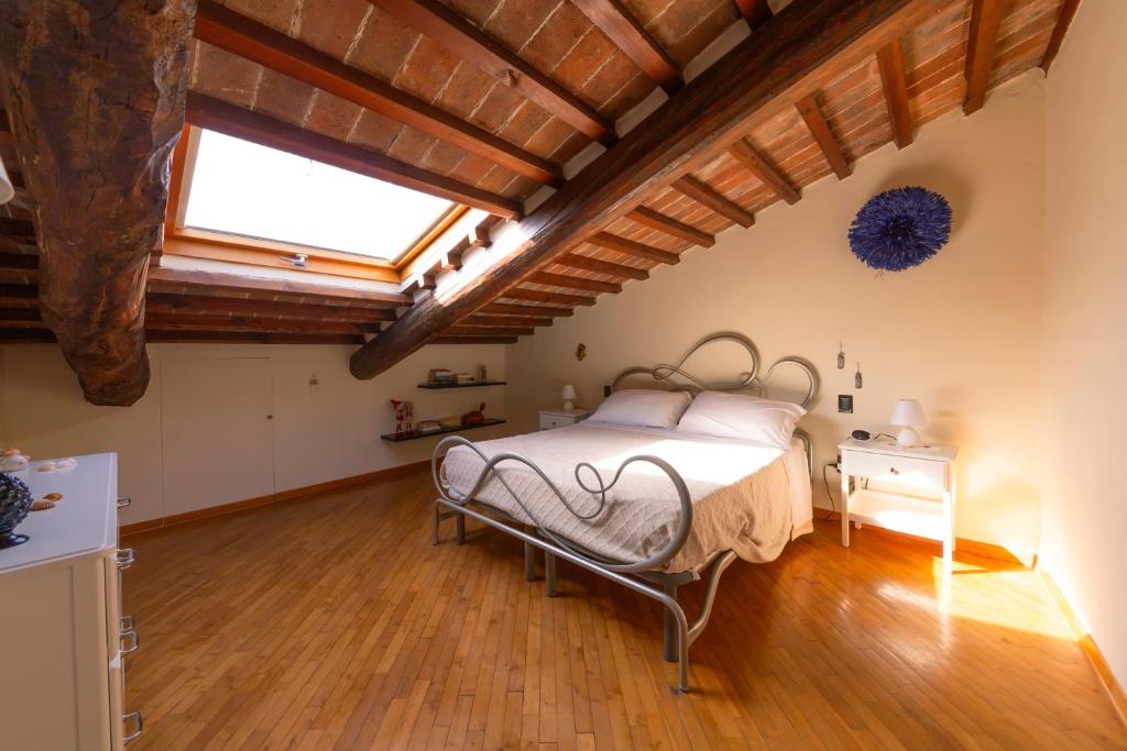 a bedroom with a bed in a room with wooden ceilings at Loft Elegance in Pistoia
