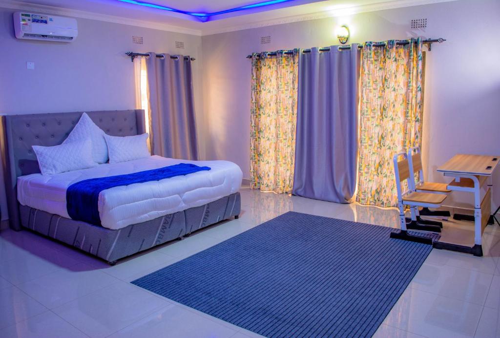 Ένα ή περισσότερα κρεβάτια σε δωμάτιο στο Gatoma Executive Lodge