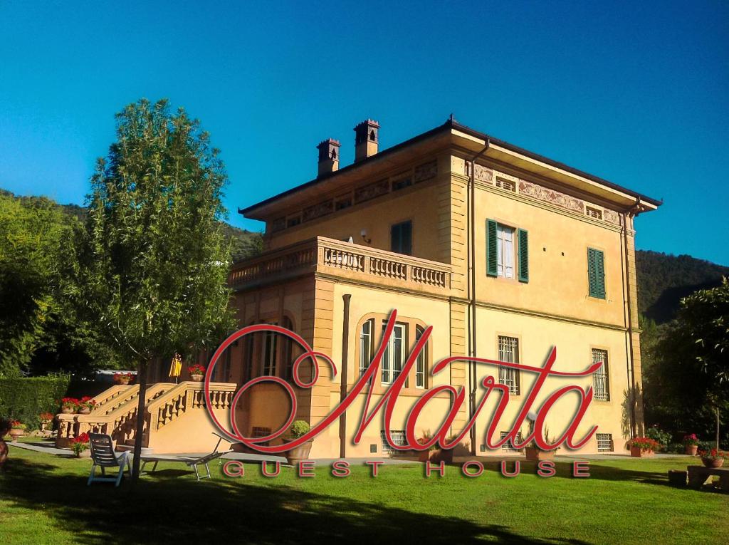 a building with a sign that reads marina guest house at Marta Guest House in Santa Maria del Giudice