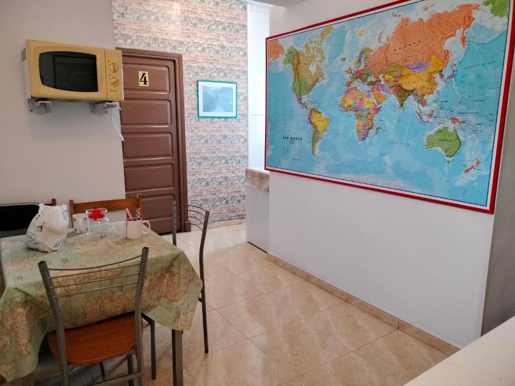 una habitación con una mesa y un mapa en la pared en Hospedaje Senda del Huerna, en Campomanes