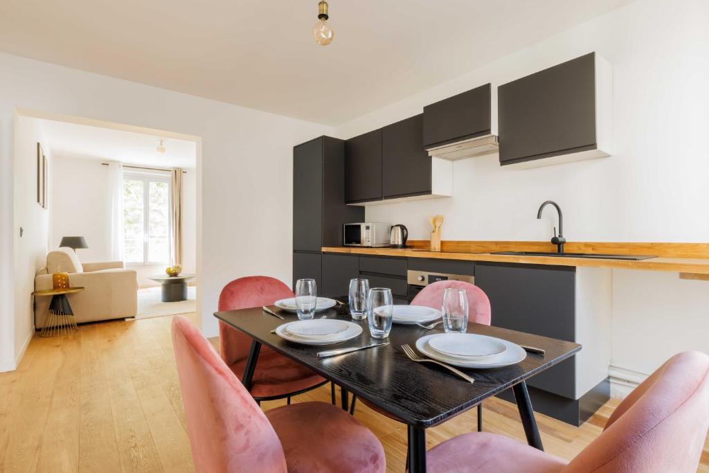 - une cuisine et une salle à manger avec une table et des chaises dans l'établissement Bright apartment near Bois de Vincennes, à Vincennes