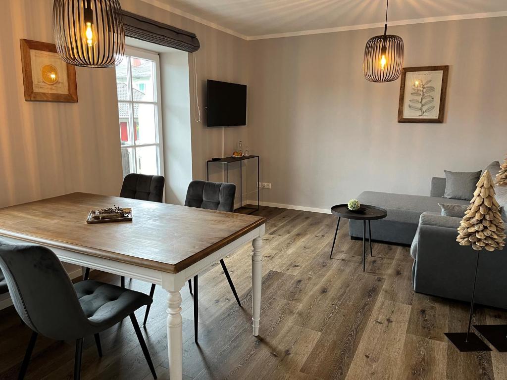 a living room with a table and a couch at Hotel zur Sonne in Rimsting