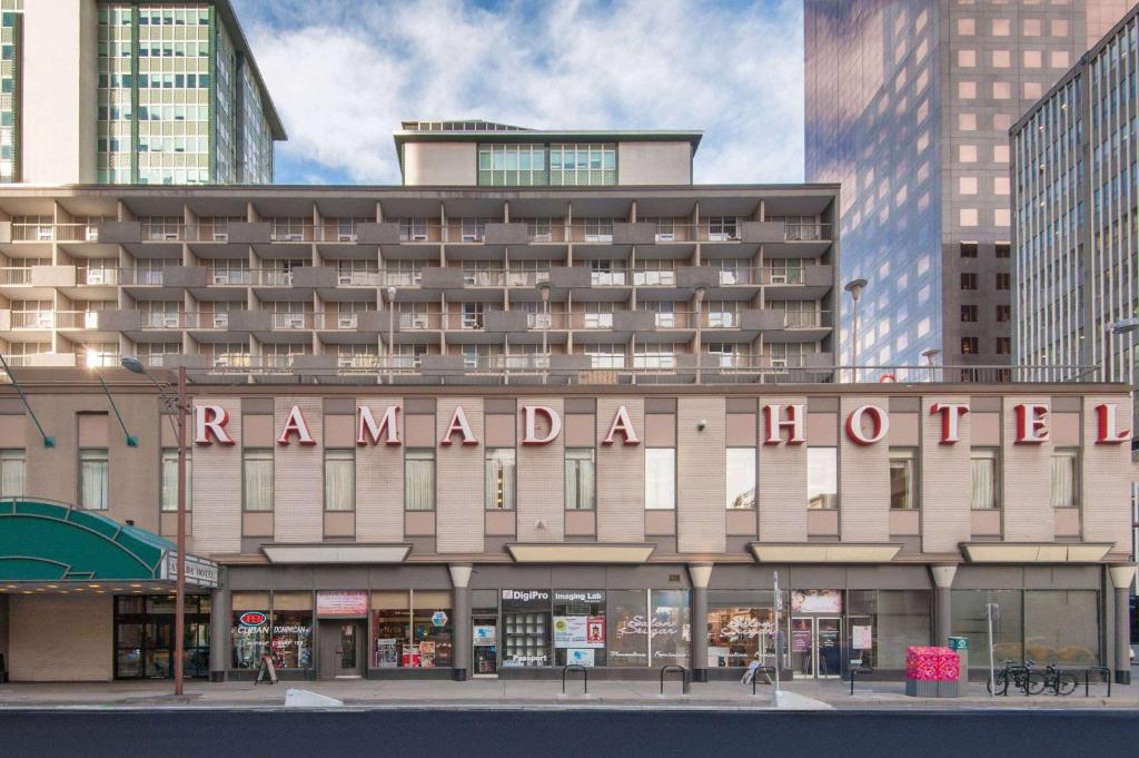 a building with a sign that reads rambala hotel at Ramada Plaza by Wyndham Calgary Downtown in Calgary