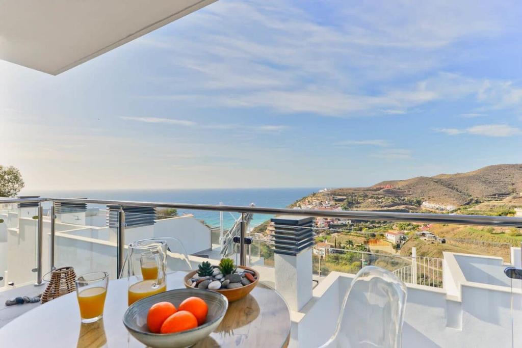 a balcony with a table with a bowl of fruit at Casa Grace in Nerja