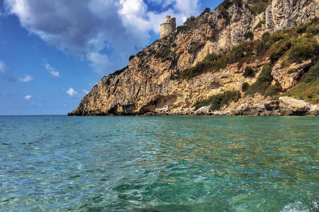 a castle on a hill next to the ocean at Il Rifugio 1711 in Borgo Vodice