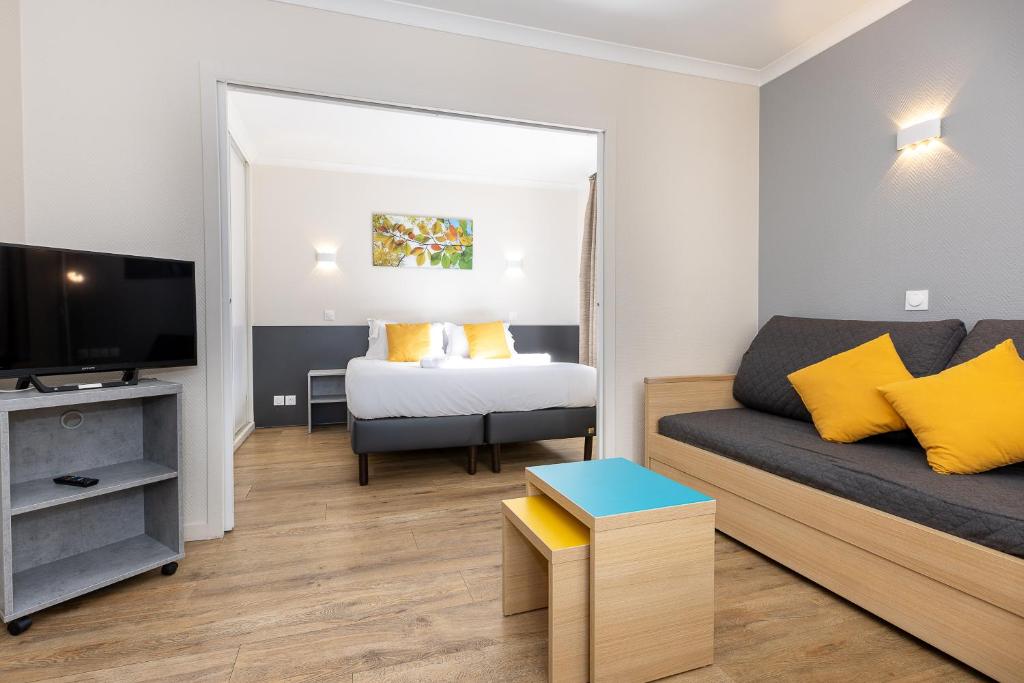 a small living room with a couch and a bed at Star Of Life in Courbevoie