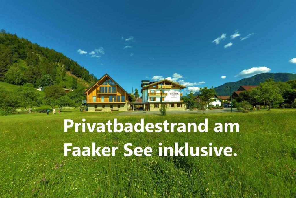 una casa in un campo di erba verde con le parole filadelbadland am di Alpen Adria Gasthof Rausch a Ledenitzen