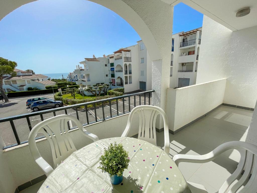 a table and chairs on a balcony with a view at Apartamentos Font Nova 3000 in Peniscola