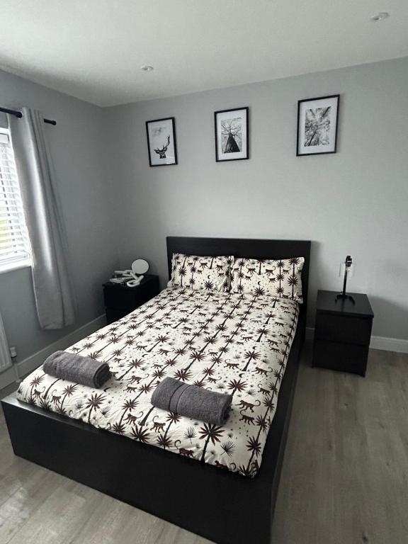 a bedroom with a bed with two pillows on it at Garreg Fawr Trearddur Bay - Ty Oren in Trearddur