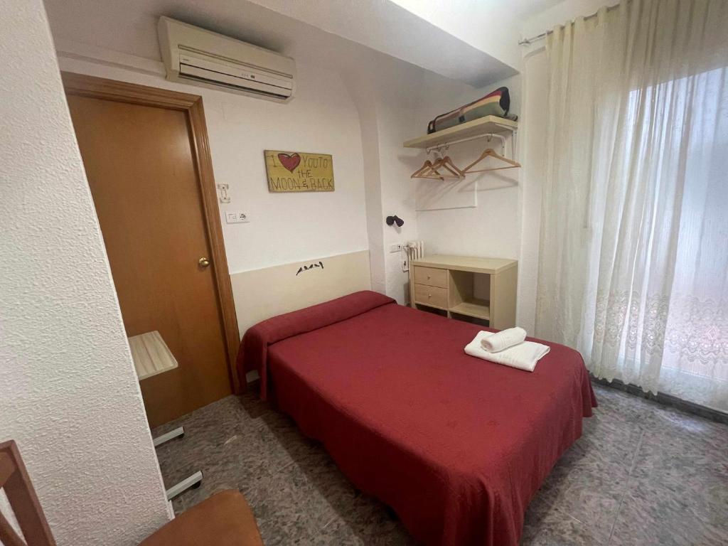 Postel nebo postele na pokoji v ubytování Hostal Cumbre