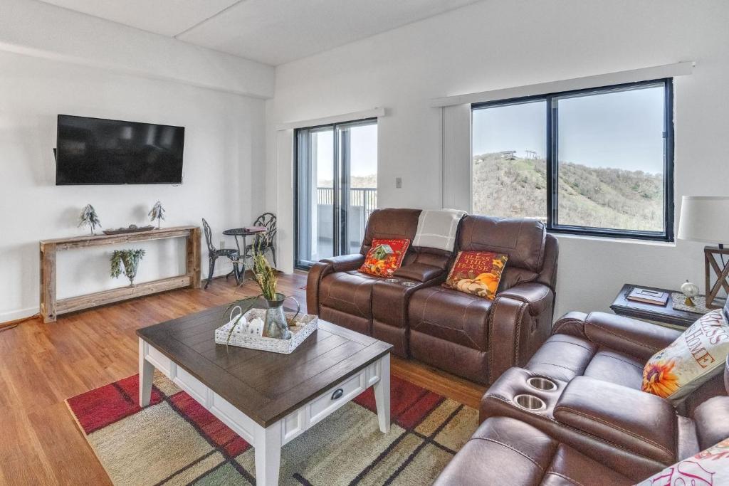 a living room with two couches and a table at Handsome 2BR Condo with Gorgeous Views in Sugar Mountain! condo in Sugar Mountain