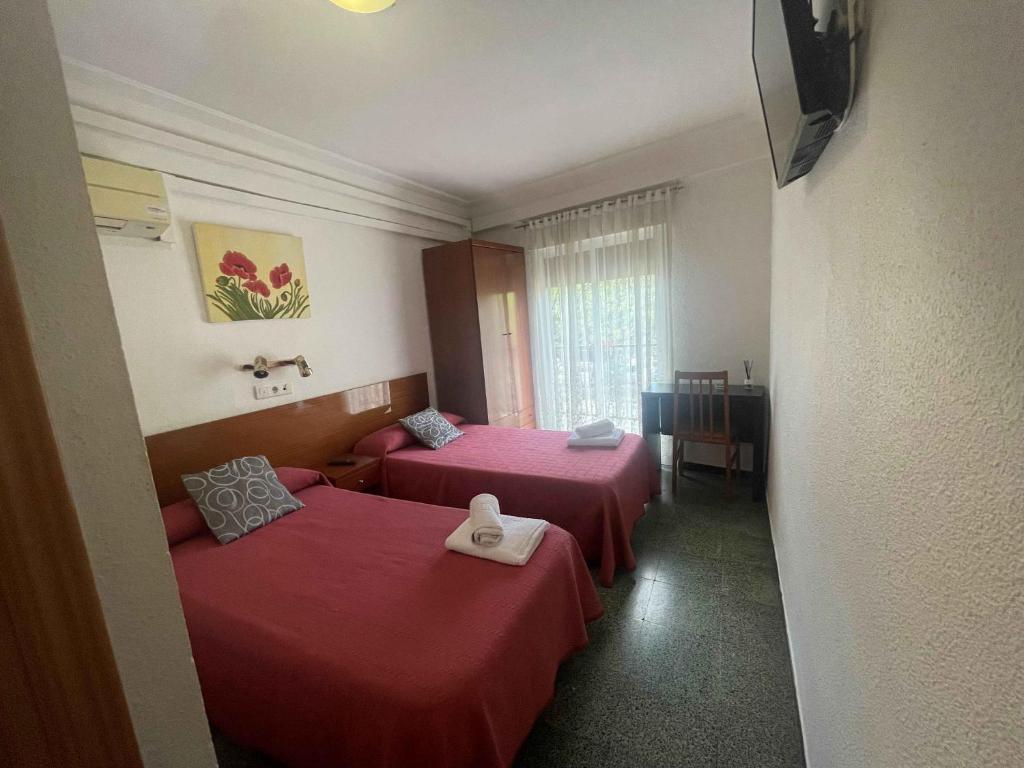 Postel nebo postele na pokoji v ubytování Hostal Cumbre