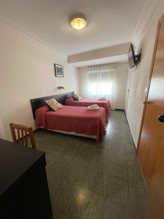 Postel nebo postele na pokoji v ubytování Hostal Cumbre