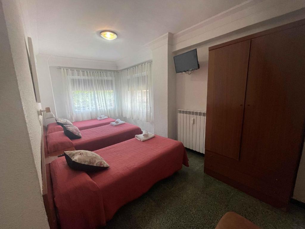 Postel nebo postele na pokoji v ubytování Hostal Cumbre
