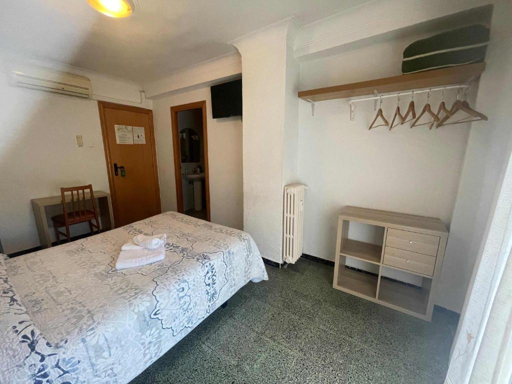 Postel nebo postele na pokoji v ubytování Hostal Cumbre